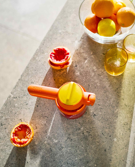 [hidden] [lifestyle] JuiceMax™ Plus Dual-Action Orange Citrus Press with Measuring Cup